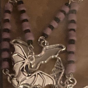 Purple and black beaded bat earrings